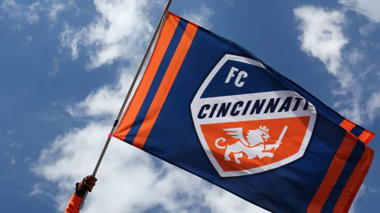 FC Cincinnati flag waving in the sky, representing soccer team pride and sports fandom.