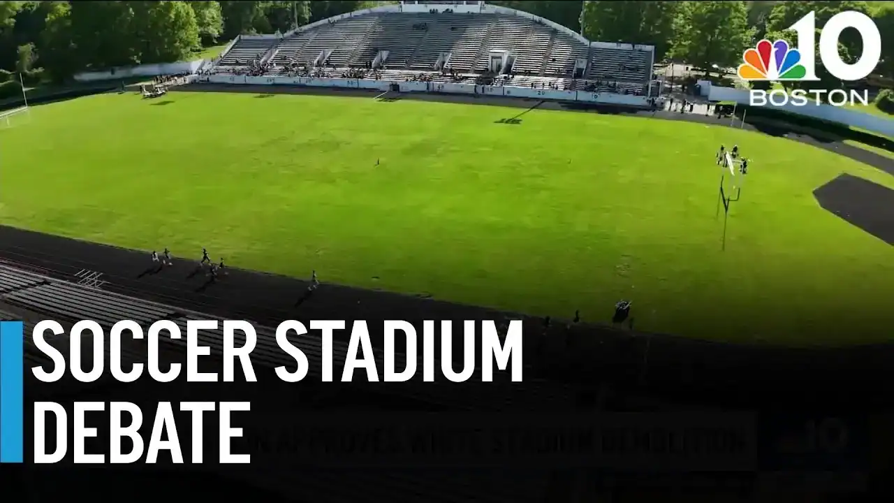 Soccer stadium with green playing field and seating area for spectators.
